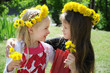Portrait of a little girls in wreaths of flowers