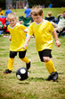 Children playing soccer in organized youth game