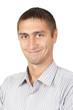 Closeup of happy young man looking at camera at studio