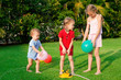 Three children playing with balloons