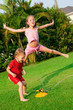 Happy children pours a water