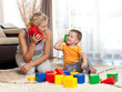 cute mother and kid boy playing together indoor
