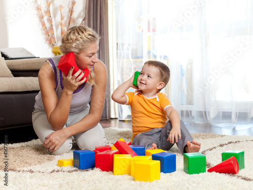 Photo: cute mother and kid boy playing together indoor cute mother and kid boy playing together indoor