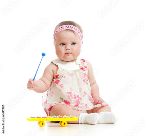 Foto: little girl baby playing with musical toy little girl baby playing with musical toy