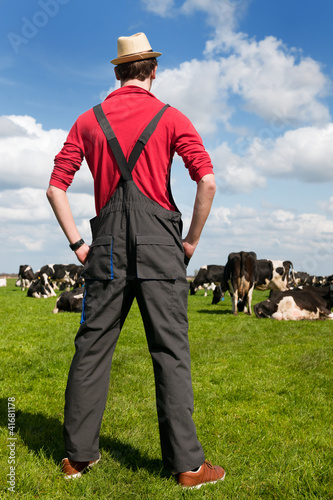 Photo: Typical Dutch landscape with farmer and cows Typical Dutch landscape with farmer and cows