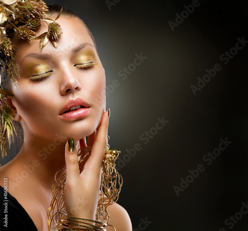 Photo: Golden Makeup. Luxury Fashion Girl Portrait Golden Makeup. Luxury Fashion Girl Portrait