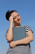Photo: Brunette young woman holding book and thinking Brunette young woman holding book and thinking