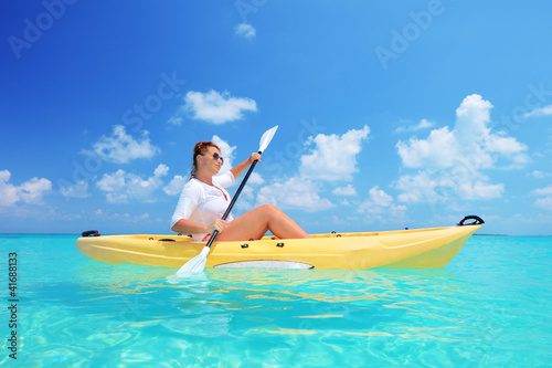 Photo: A woman kayaking on a sunny day A woman kayaking on a sunny day