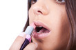 woman applying lipstick woman applying lipstick