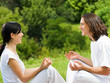 Young couple meditating together, outdoors