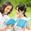 Young couple or students, reading a book Young couple or students, reading a book