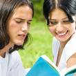 Young couple or students, reading a book Young couple or students, reading a book