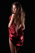 woman in red silk on dark background