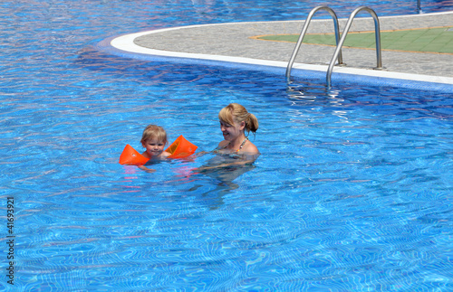 Photo: Girl with her mother in the swimming pool Girl with her mother in the swimming pool