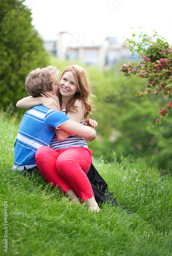 Photo: Young happy couple having fun together in park Young happy couple having fun together in park