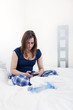 Young woman texting in bed