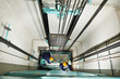 machinists adjusting lift in elevator hoistway