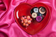 Heart shape plate with buttons on pink wave background