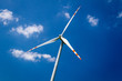 Power generating wind turbines on blue sky background Power generating wind turbines on blue sky background