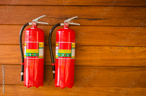 Photo: extinguisher on wooden wall extinguisher on wooden wall