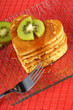 Stack of heart-shaped pancakes with syrup and kiwi fruit Stack of heart-shaped pancakes with syrup and kiwi fruit