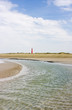 Beach with creek, dunes and lighthouse Beach with creek, dunes and lighthouse