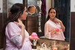 Young pregnant woman with cosmetic cream.