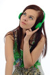 Young brunette focuses on music from headphones