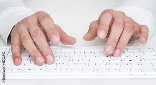 Photo: Close up of human hands typing at the keyboard Close up of human hands typing at the keyboard