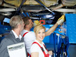 Happy apprentice and two assembly operators in a garage