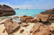The white sand of a beach adjoins with rocks