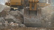 Excavator moving large rocks