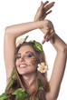 Beautiful young woman with flowers, leaves in her hair and origi Beautiful young woman with flowers, leaves in her hair and origi