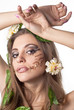 Portrait of beautiful young lady with flower and leaf in her ha Portrait of beautiful young lady with flower and leaf in her ha