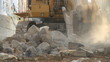 Excavator moving large rocks