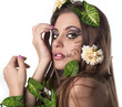 Beautiful young woman with flowers, leaves in her hair and origi Beautiful young woman with flowers, leaves in her hair and origi