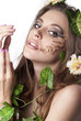 Beautiful young woman with flowers, leaves in her hair and origi Beautiful young woman with flowers, leaves in her hair and origi
