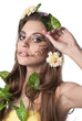 Beautiful young woman with flowers, leaves in her hair and origi Beautiful young woman with flowers, leaves in her hair and origi