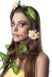 Beautiful young woman with flowers, leaves in her hair and origi Beautiful young woman with flowers, leaves in her hair and origi