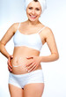Foto: pregnant young female with cosmetic cream pregnant young female with cosmetic cream