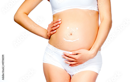 Foto: pregnant young female with cosmetic cream pregnant young female with cosmetic cream