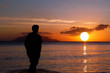 Photo: Lone on sunset . Man on paradise sunset beach. Lone on sunset . Man on paradise sunset beach.