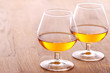 Glass of cognac over wooden surface