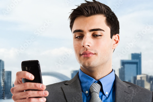 Photo: Businessman using his mobile phone Businessman using his mobile phone