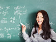 Schoolchild writing on blackboard.