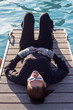Foto: Woman Lying On A Pier Woman Lying On A Pier