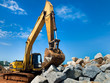 Yellow tracked excavator with rock Yellow tracked excavator with rock