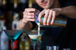 barmen mixes a cocktail