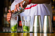 barmen mixes a cocktail