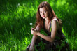 brunette lying on green grass